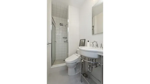a bathroom with a toilet a sink and a mirror