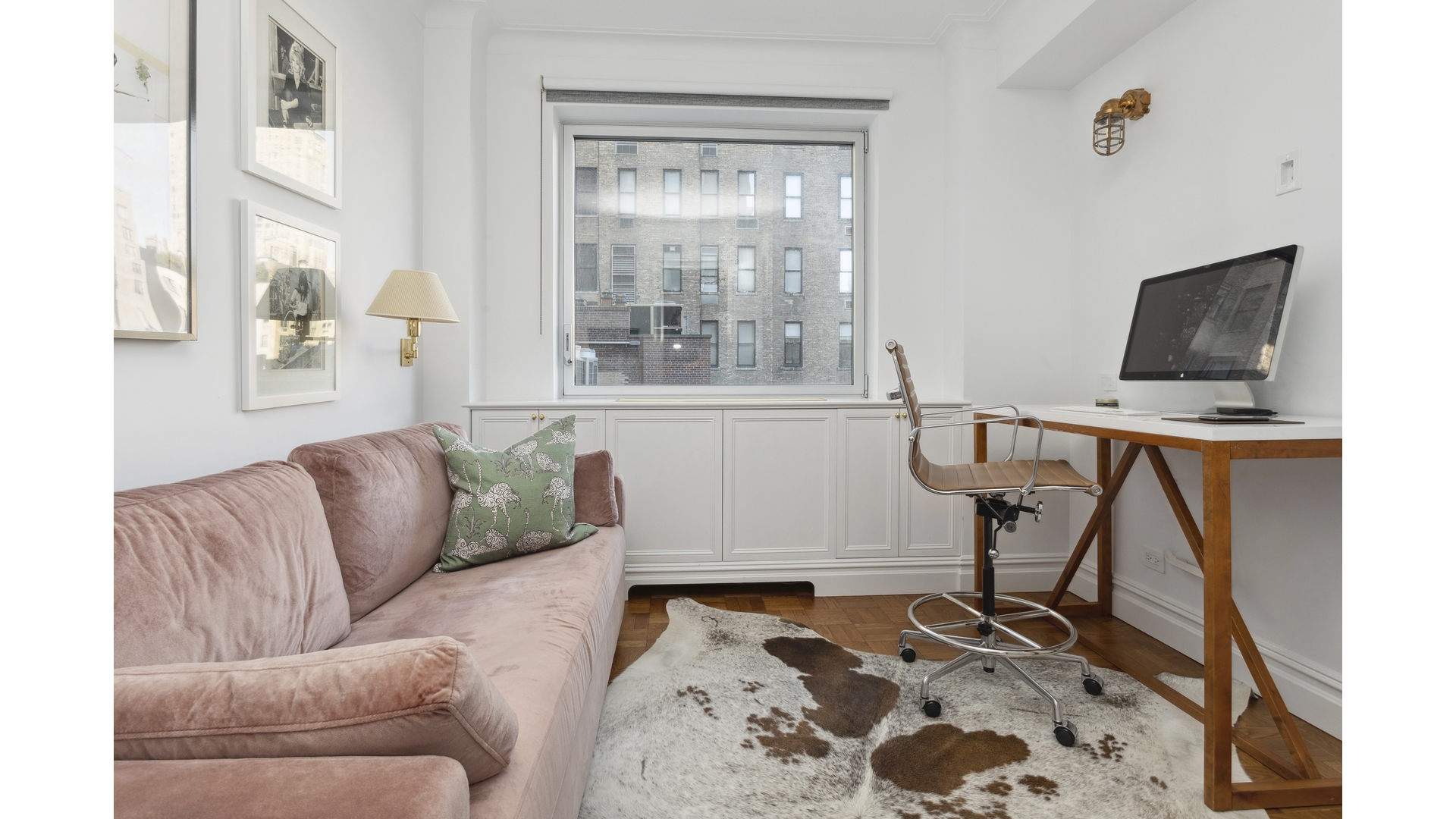 923 5th Avenue, Unit 9G Manhattan, NY 10021 - Photo 10 of 13 a living room with furniture and a flat screen tv