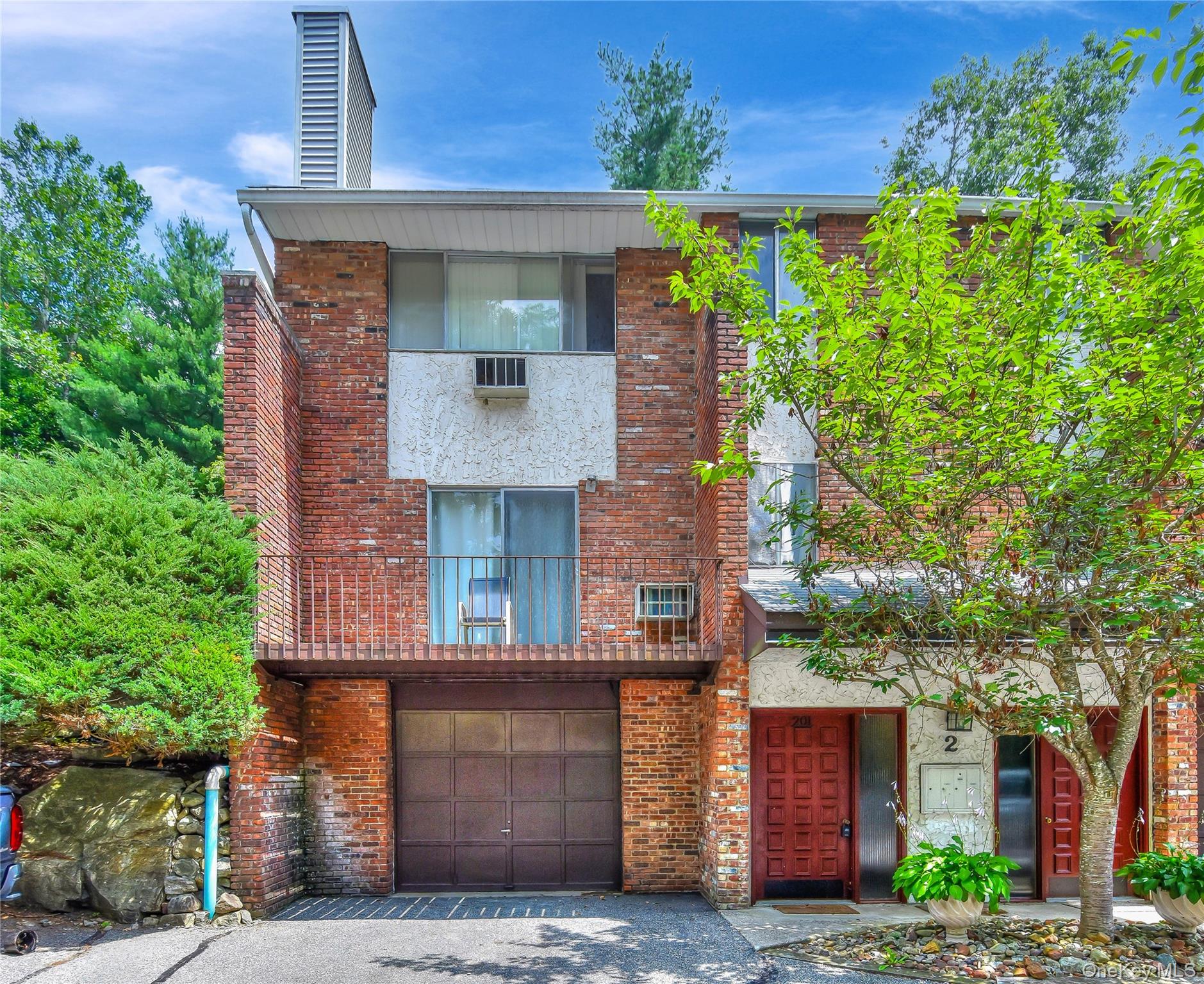 a front view of a house with plants