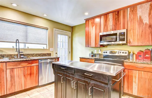a kitchen with a sink a stove and cabinets