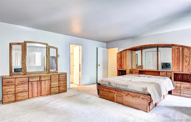 a spacious bedroom with a large bed and a large window