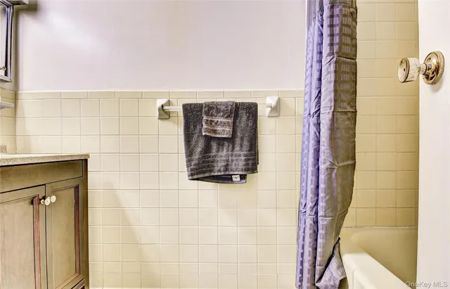 a bathroom with a shower and a sink