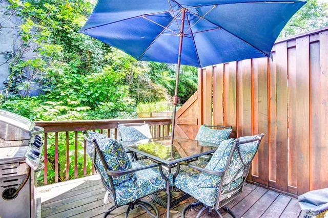 a view of an outdoor sitting area with furniture and umbrella