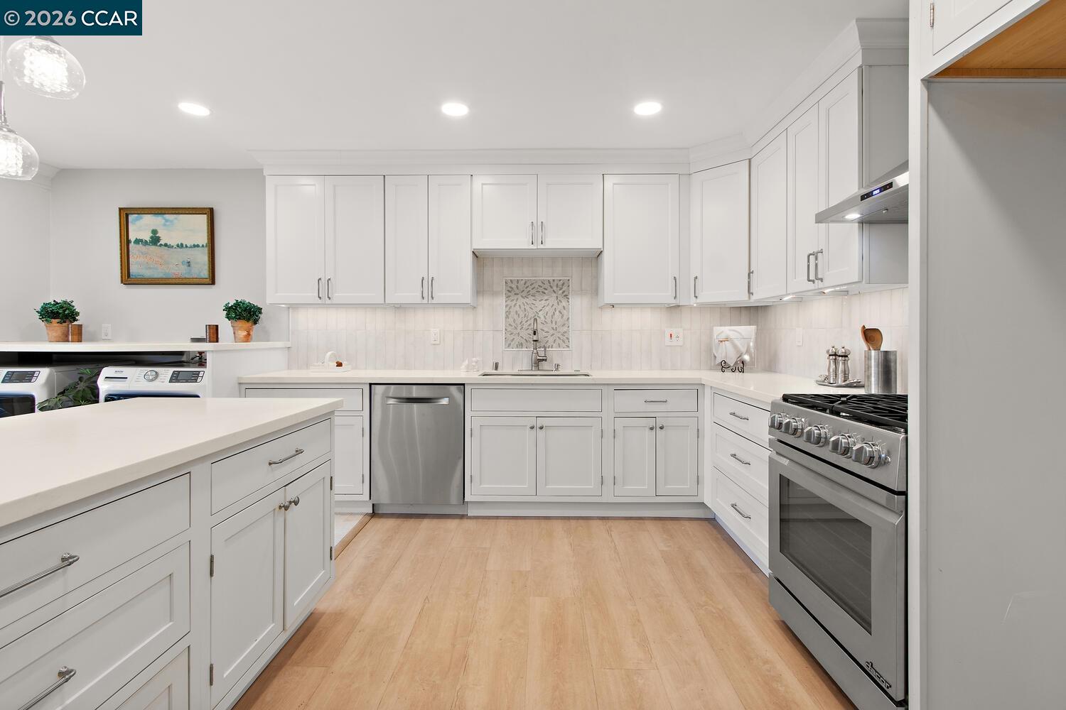 1132 Running Springs Road, Unit 11 Walnut Creek, CA 94595 - Photo 5 of 18 a kitchen with white cabinets appliances and sink