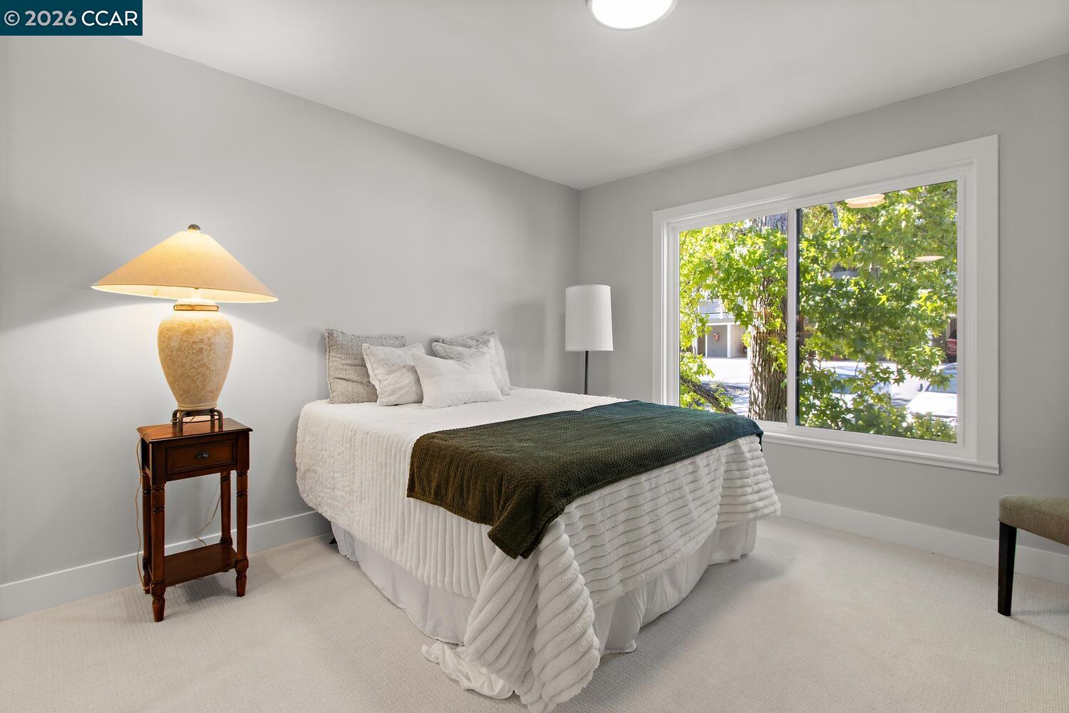 1132 Running Springs Road, Unit 11 Walnut Creek, CA 94595 - Photo 7 of 18 a bedroom with a bed lamp on table and a window
