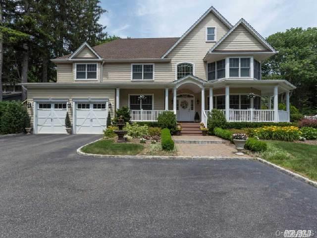 157 Southdown Road Huntington, NY 11743 - Photo 1 of 1 a front view of a house with a yard and garage