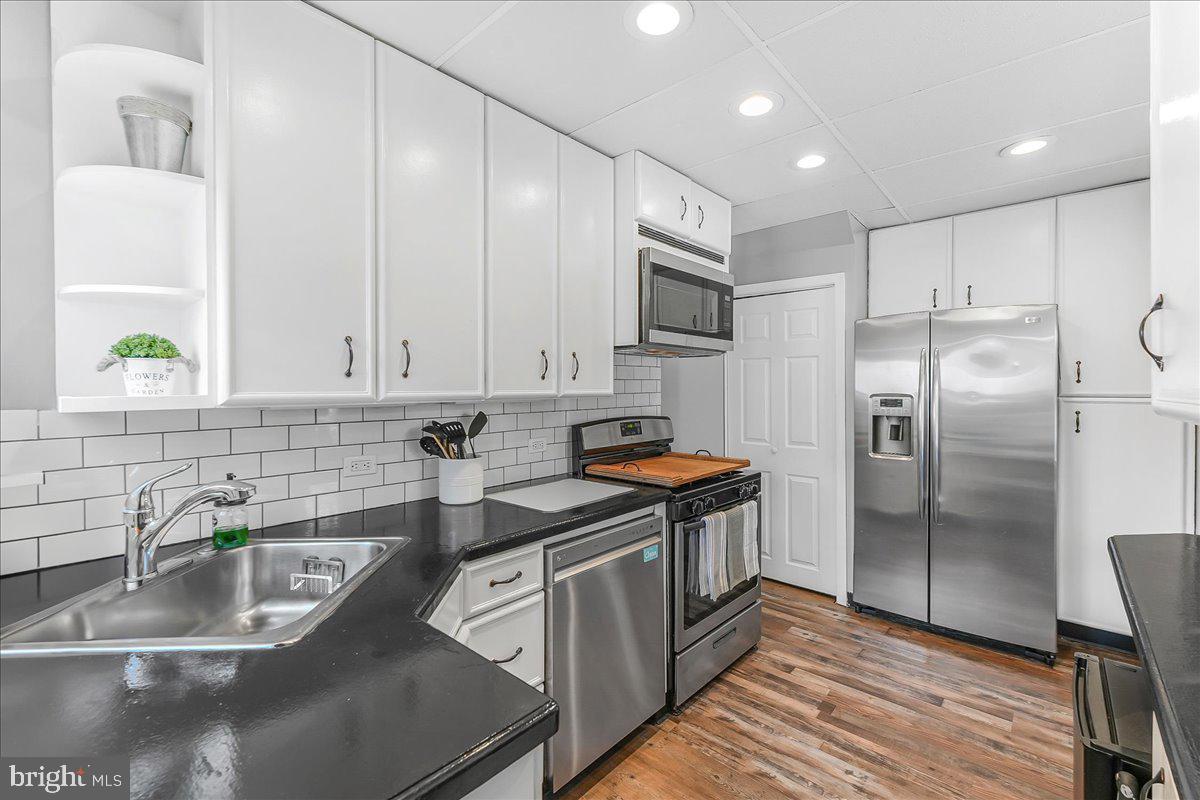 244 Sedgewood Road Springfield, PA 19064 - Photo 16 of 31 a kitchen with stainless steel appliances granite countertop a sink a stove and a refrigerator