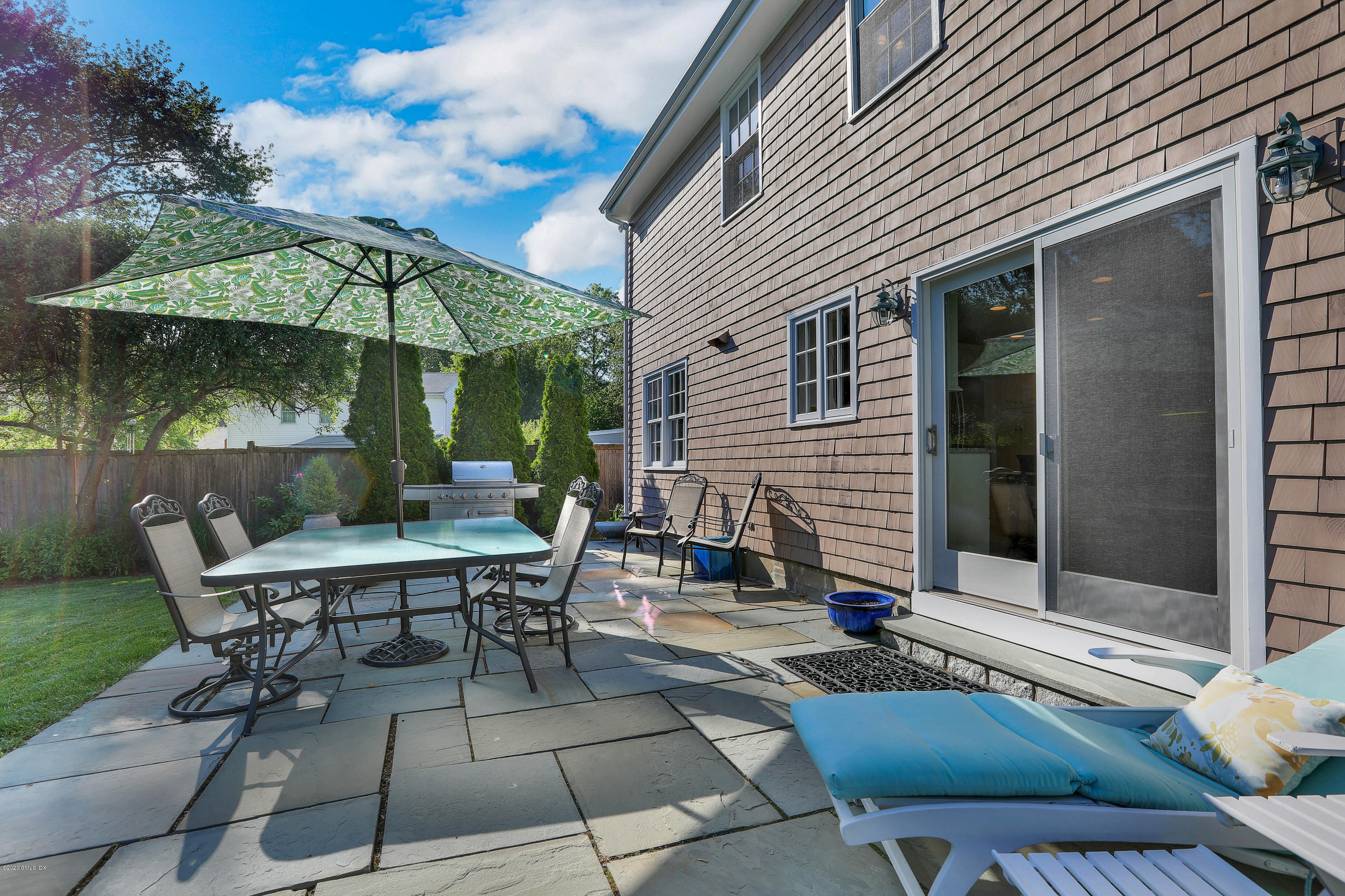 38 Split Timber Place Riverside, CT 06878 - Photo 17 of 24 a view of a patio with a table and chairs under an umbrella