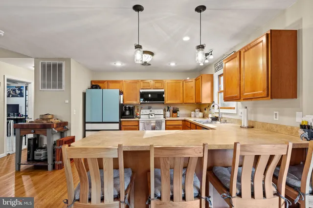 a large kitchen with a table and chairs