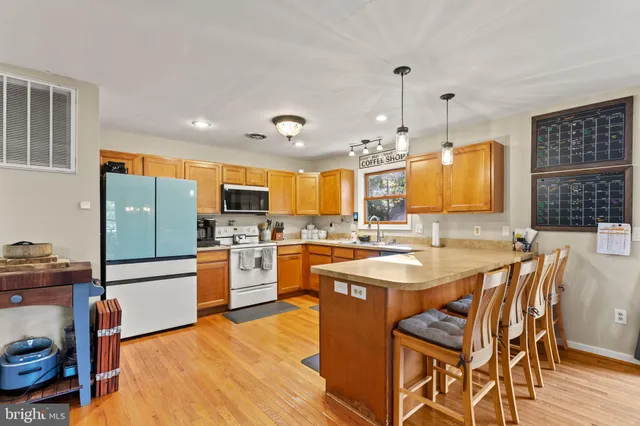 a large kitchen with a table and chairs