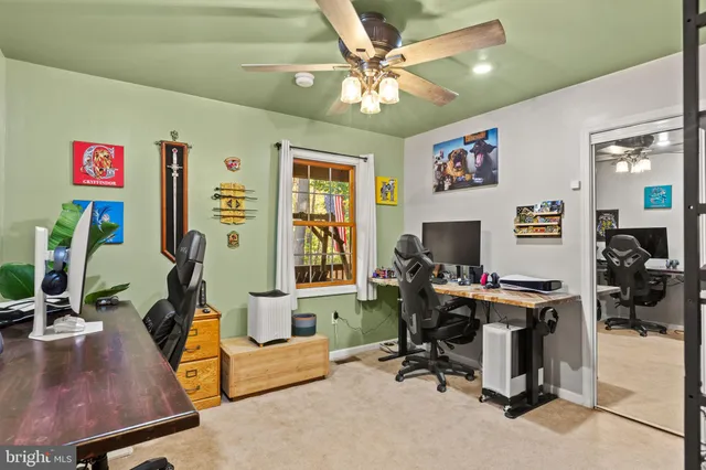 a view of a workspace with furniture and a flat screen tv