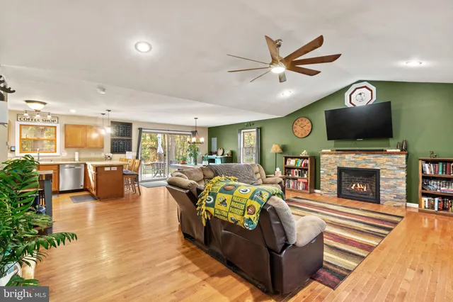 a living room with furniture a fireplace and a flat screen tv