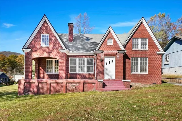 a front view of house with yard and outdoor seating