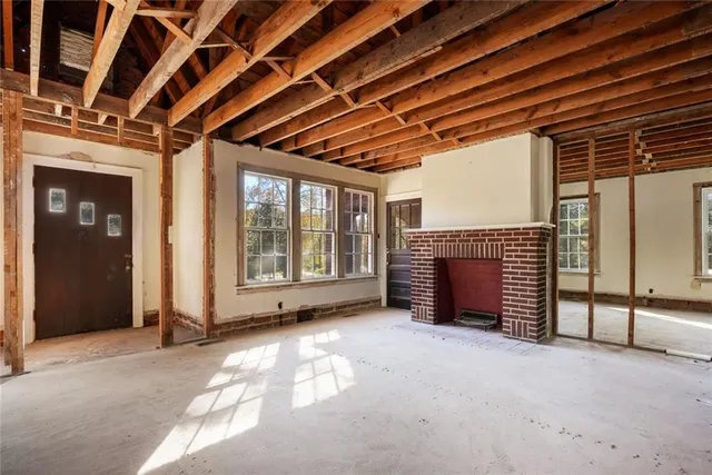 a view of an empty room with a fireplace