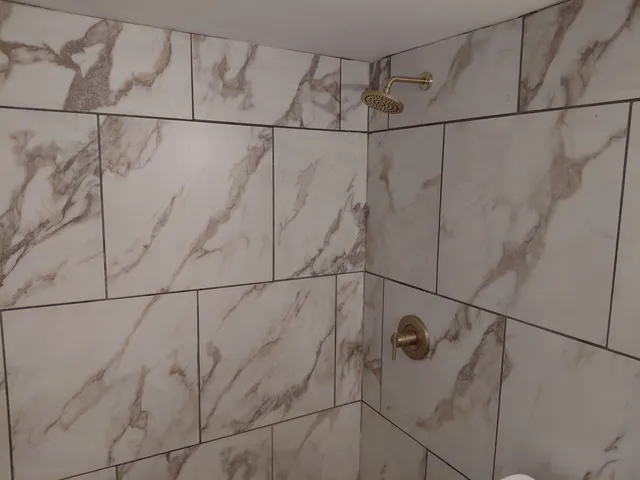 a bathroom with a shower and a shower head