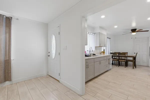 a view of a hallway with wooden floor