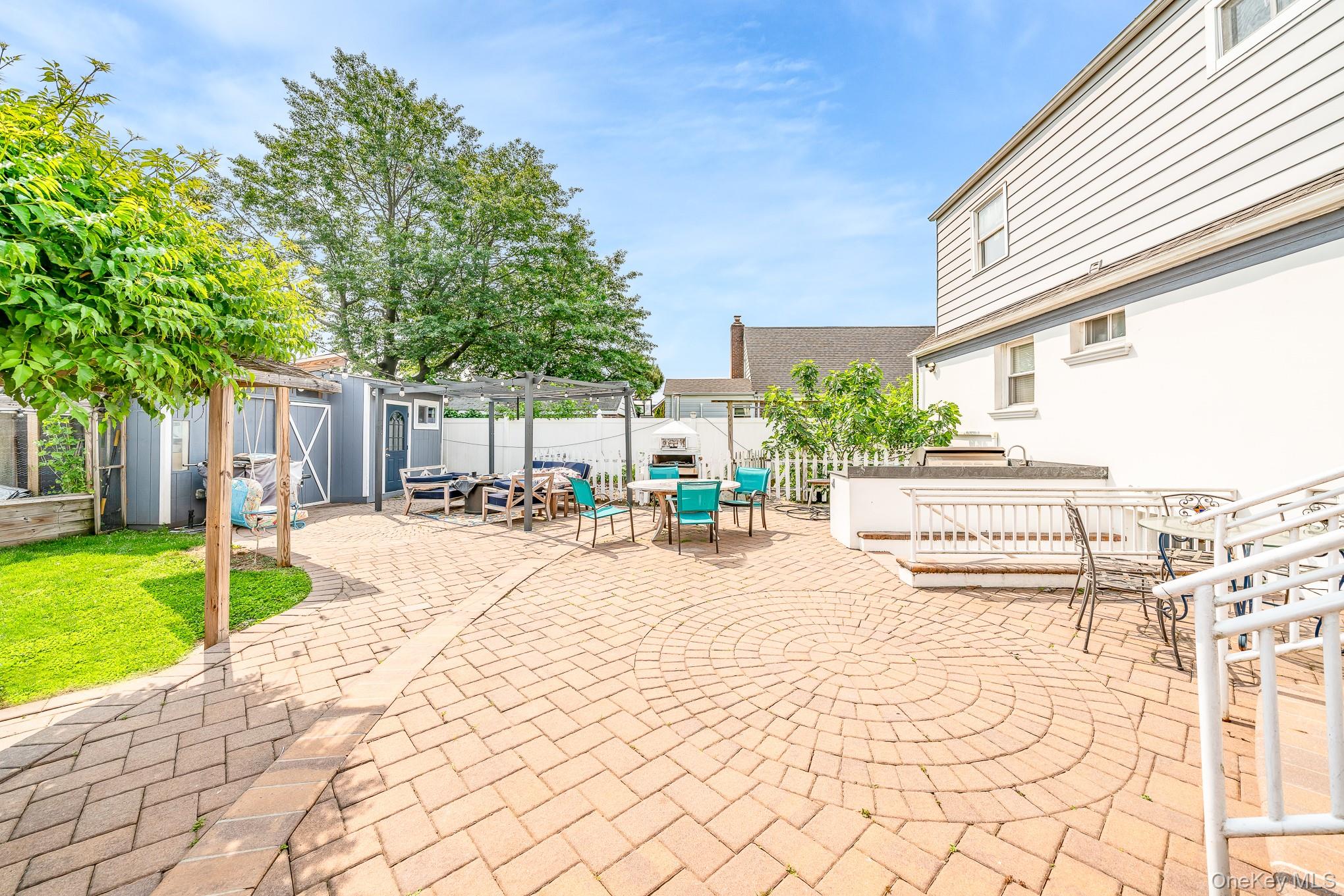 136 Wardwell Road Mineola, NY 11501 - Photo 5 of 25 View of patio / terrace with outdoor dining area and an outdoor structure