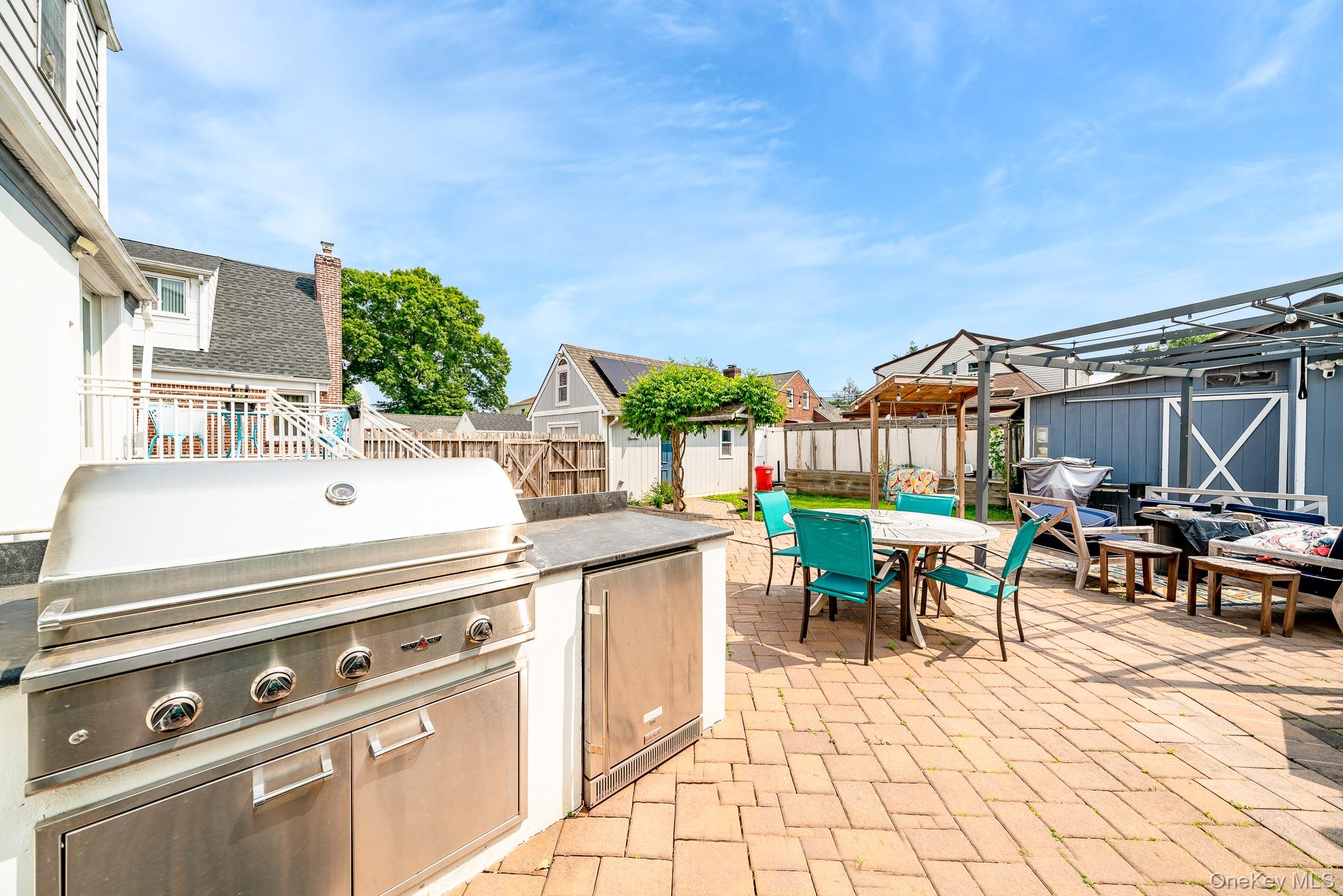 136 Wardwell Road Mineola, NY 11501 - Photo 6 of 25 Fenced backyard featuring outdoor dining area, a patio, and a residential view