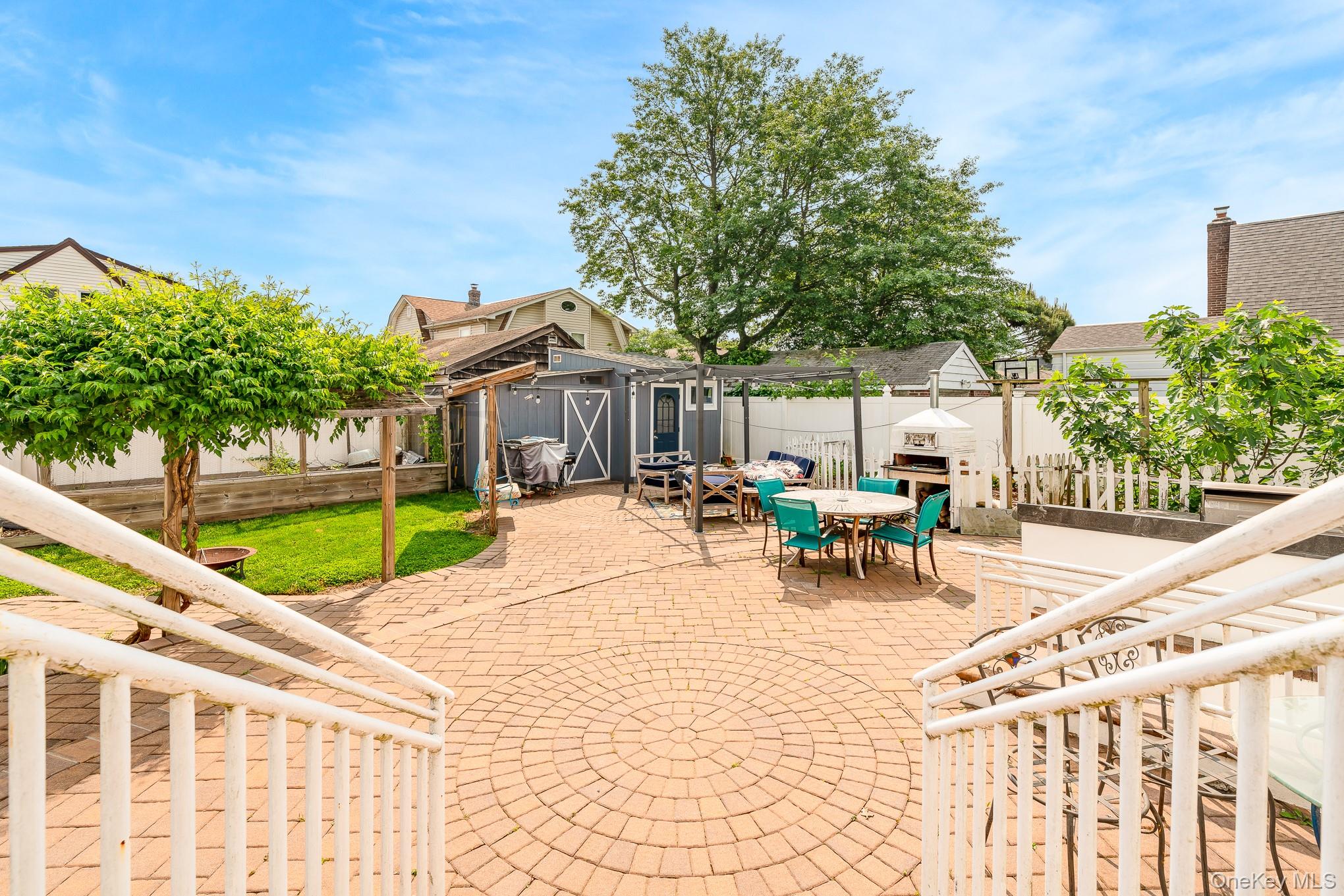 136 Wardwell Road Mineola, NY 11501 - Photo 9 of 25 Fenced backyard with outdoor dining space and a patio area