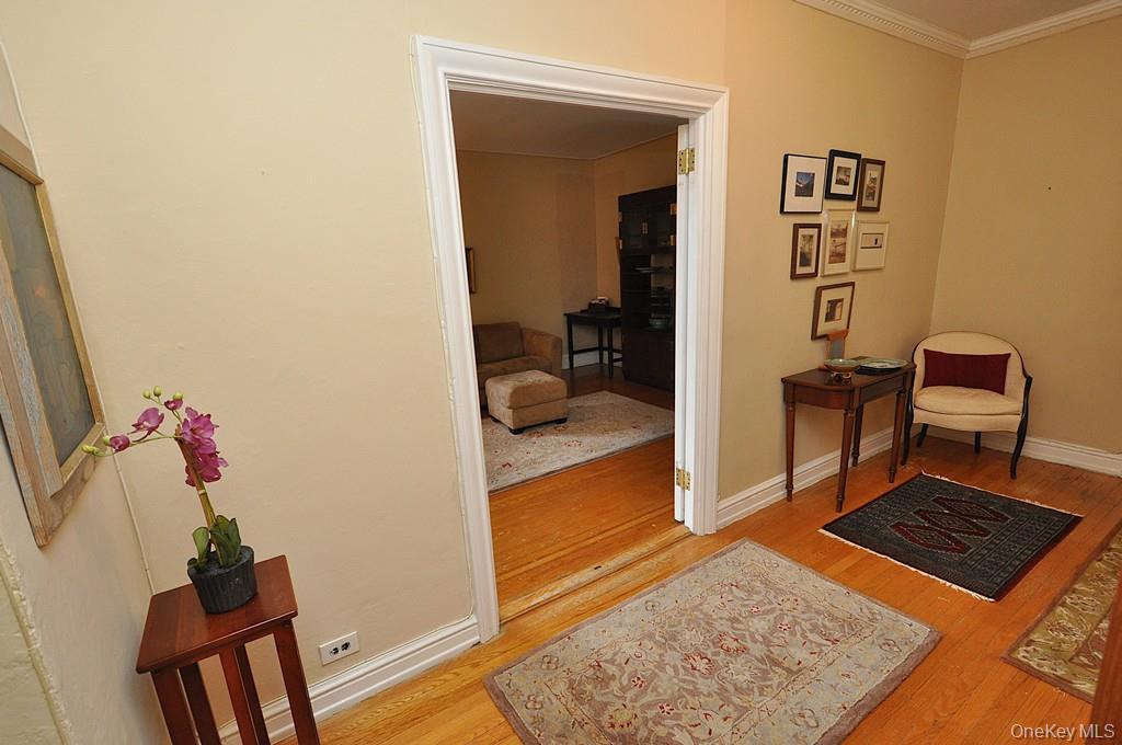 143 Garth Road, Unit 5J Scarsdale, NY 10583 - Photo 25 of 47 a living room with furniture and a rug