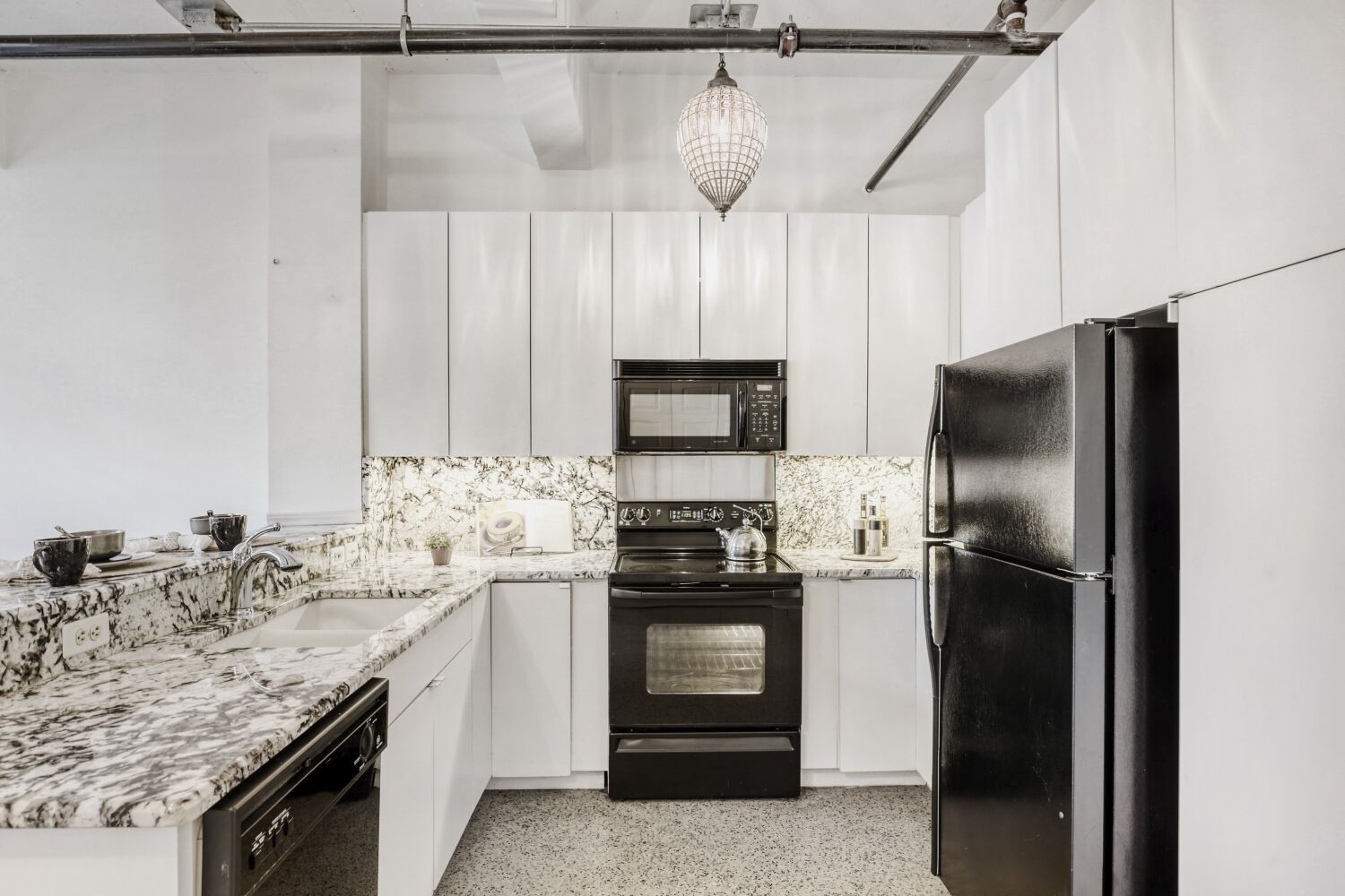 710 Colorado Street, Unit 4G Austin, TX 78701 - Photo 9 of 39 a kitchen with stainless steel appliances granite countertop a refrigerator and a stove