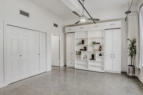 a spacious bedroom with a bed and a shower