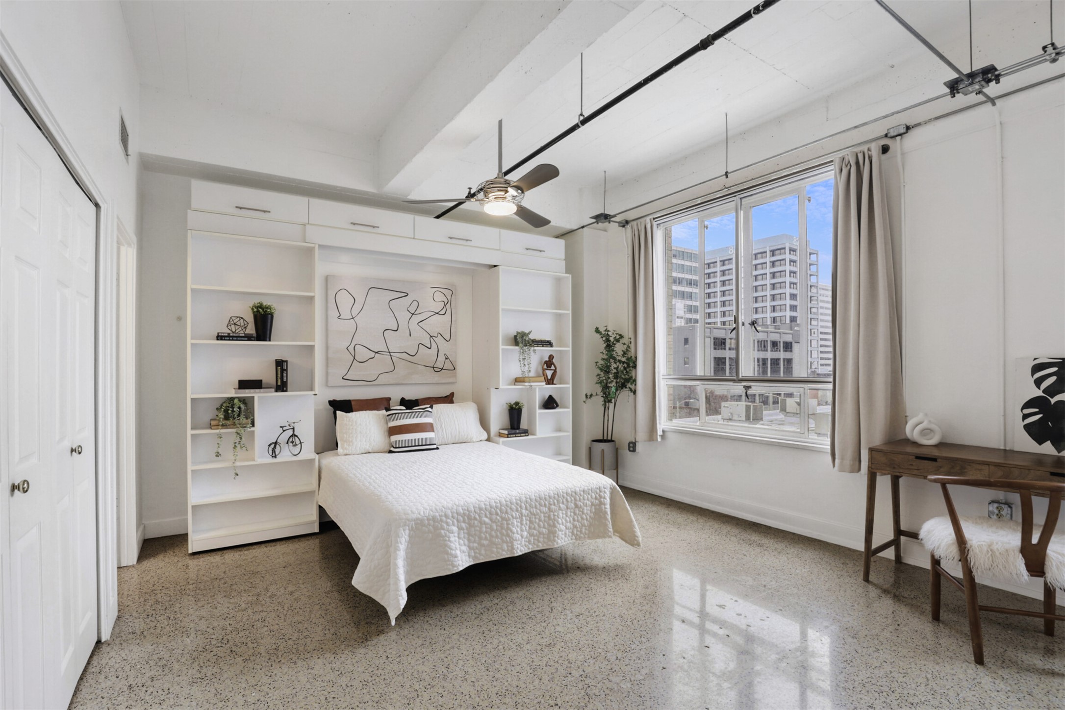 710 Colorado Street, Unit 4G Austin, TX 78701 - Photo 13 of 39 a bedroom with a bed couch and a window