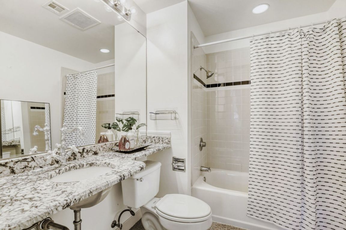 710 Colorado Street, Unit 4G Austin, TX 78701 - Photo 18 of 39 The full bathroom comes with a shower/tub combo surrounded in tile backsplash.