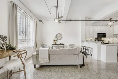 a view of a kitchen with furniture and a refrigerator