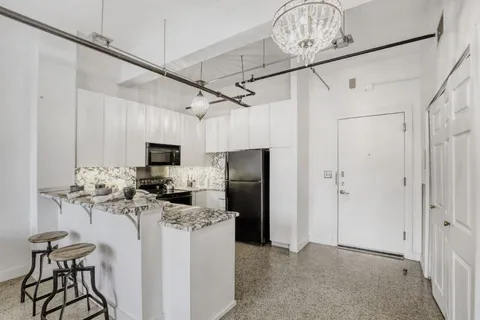 a view of a kitchen with furniture and a window
