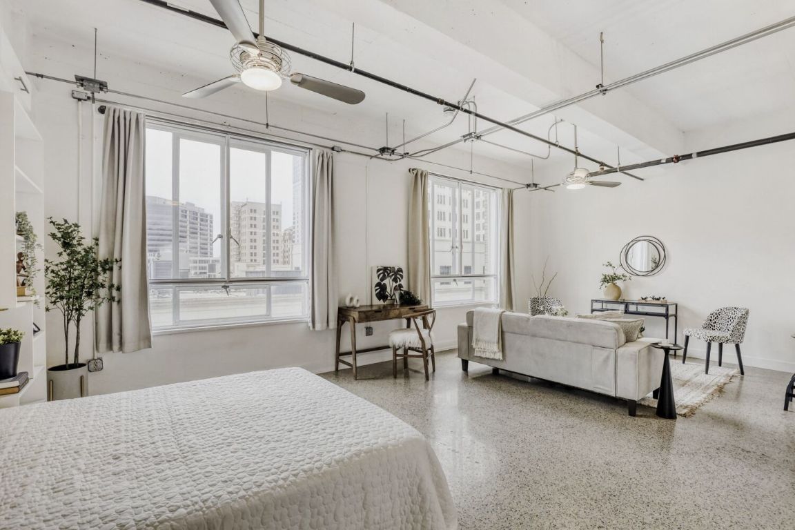 710 Colorado Street, Unit 4G Austin, TX 78701 - Photo 6 of 39 East-facing downtown views flood the space with natural light, reflecting off nearby buildings and casting warm sunset hues in the late afternoon.