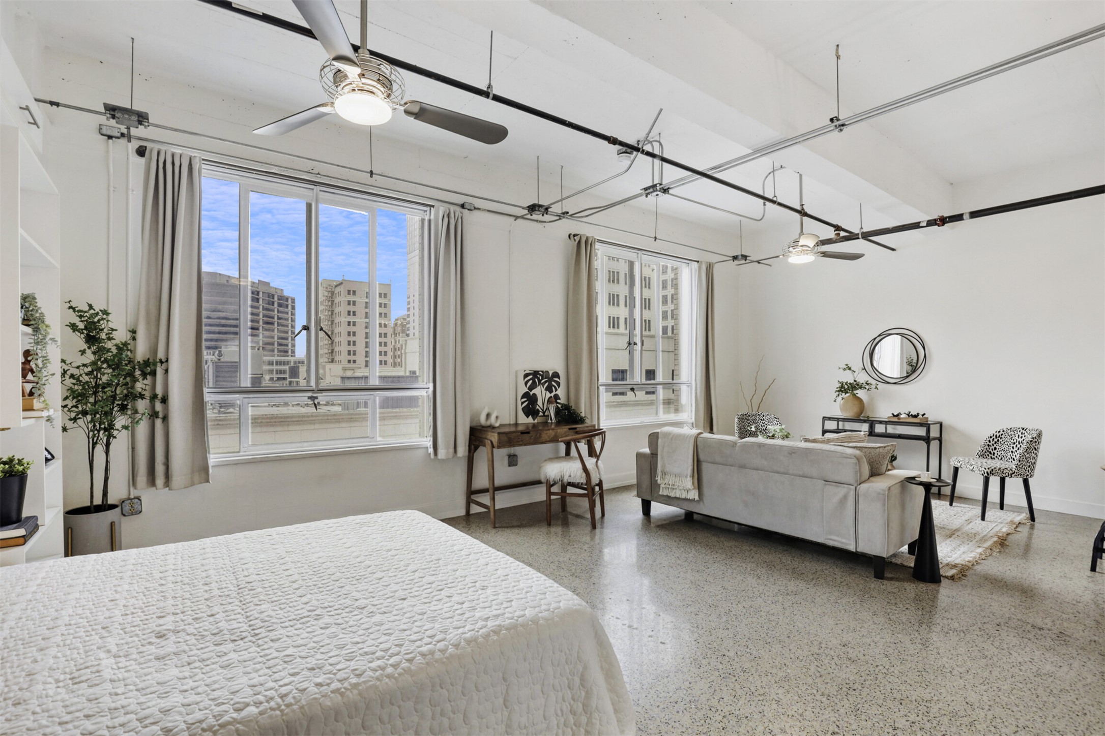 710 Colorado Street, Unit 4G Austin, TX 78701 - Photo 6 of 39 East-facing downtown views flood the space with natural light, reflecting off nearby buildings and casting warm sunset hues in the late afternoon.