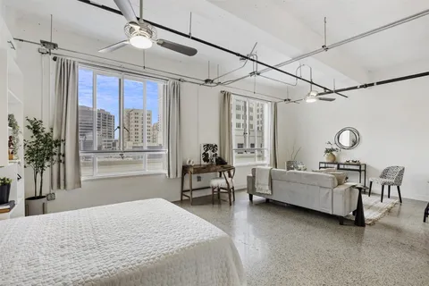 a living room with furniture a rug and a window