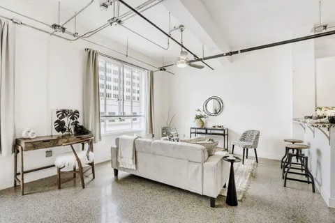 a living room with furniture and a chandelier