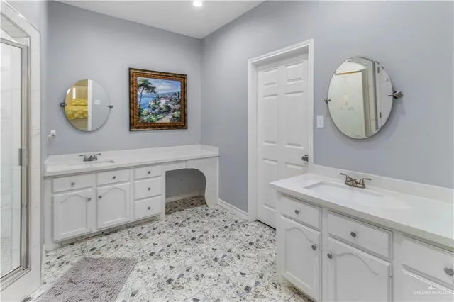 a spacious bathroom with a sink mirror and vanity