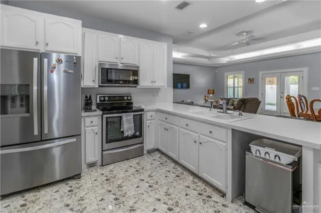 a kitchen with a sink stainless steel appliances and cabinets
