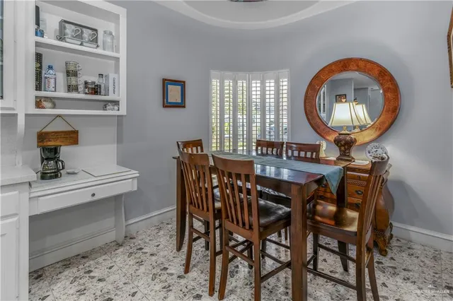 a view of a dining room with furniture and a chandelier