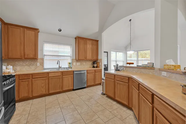 a kitchen with a sink window and cabinets