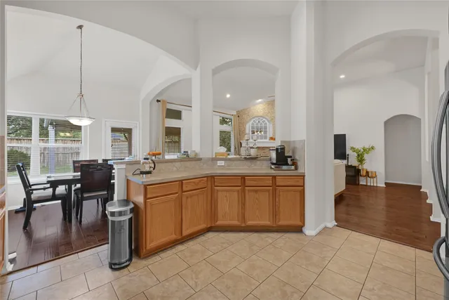 a large kitchen with lots of counter top and dining table