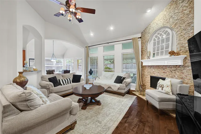 a living room with furniture fireplace and a large window