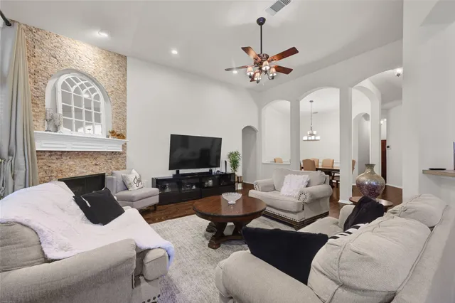 a living room with furniture a fireplace and a flat screen tv