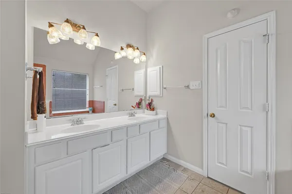 a bathroom with a double vanity sink and a mirror