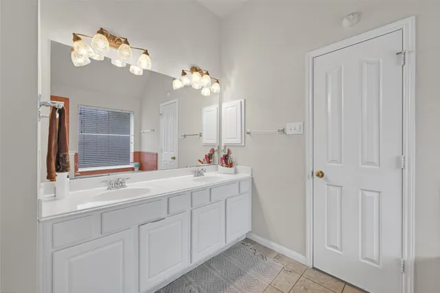 a bathroom with a double vanity sink and a mirror