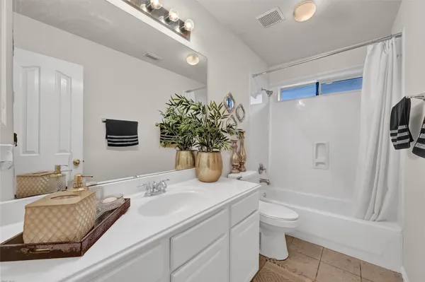 a bathroom with a granite countertop sink a toilet and shower