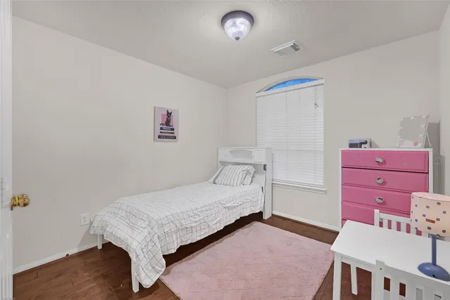 a bedroom with a bed and a dresser