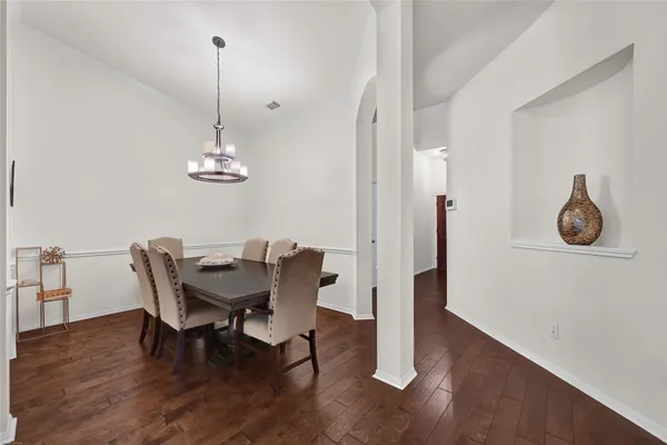 a view of a dining room with furniture wooden floor and chandelier