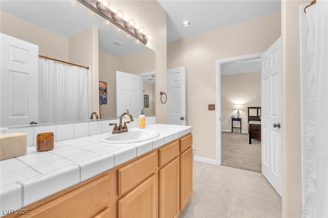2251 Thoroughbred Road Henderson, NV 89002 - Photo 20 of 60 Bathroom with tile patterned floors, vanity, baseboards, and visible vents