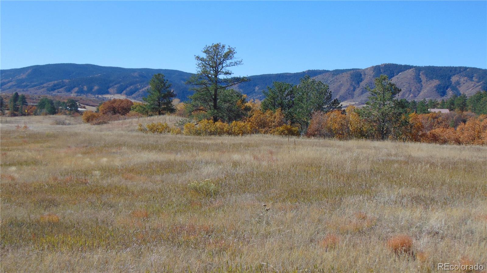 4771 Jackson Creek Road Sedalia, CO 80135 - Photo 11 of 19 a view of a town with mountains in the background