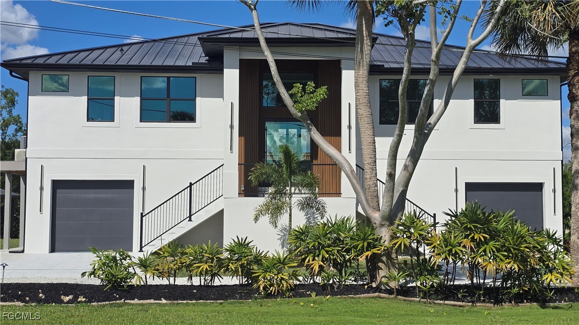 18190 Pioneer Road Fort Myers, FL 33908 - Photo 1 of 45 a front view of a house with garden