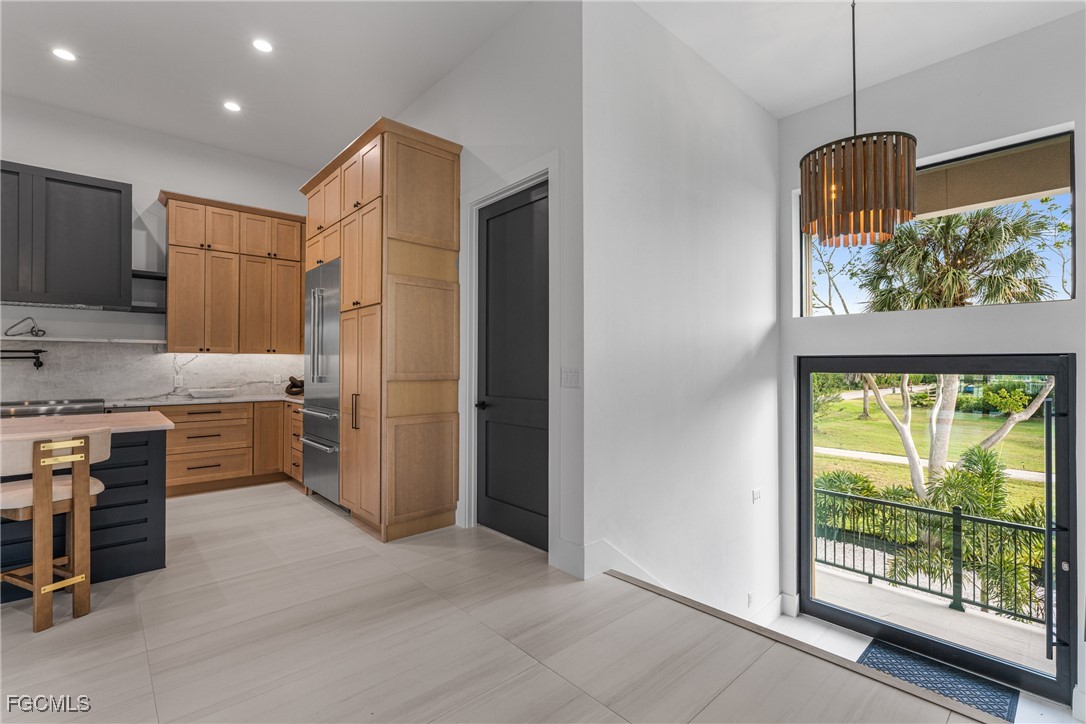18190 Pioneer Road Fort Myers, FL 33908 - Photo 17 of 45 a kitchen with kitchen island a counter top space a sink stainless steel appliances and cabinets
